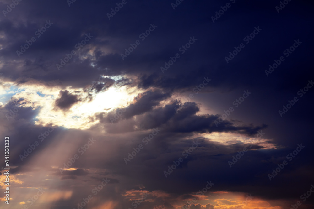 Sunlight rays and cloudy heaven . Fantastic dark clouds with sunlight Sunlight rays and cloudy heaven . Fantastic dark clouds with sunlight