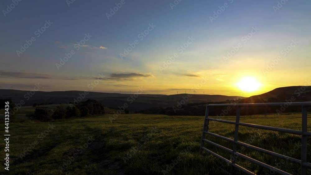Timelapse Sunset Over Green Hills, White Clouds Float Above The Green Hills In Yorkshire With Gate Timelapse Sunset Over Green Hills, White Clouds Float Above The Green Hills In Yorkshire With Gate