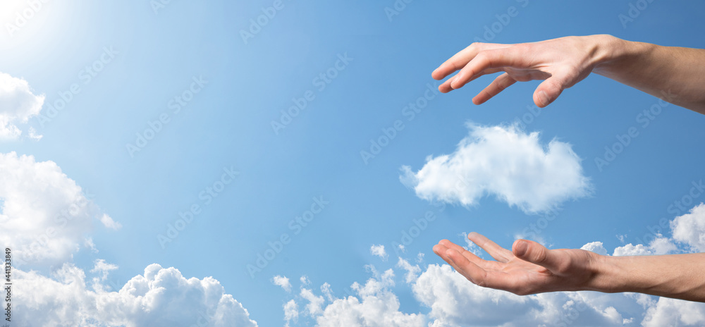 Male hand holding house icon on blue background. Property insurance and security concept.Real estate concept.Weather conditions, cloudiness.Banner with copy space