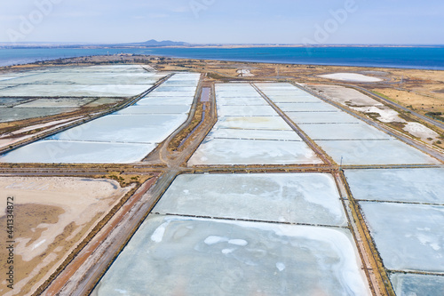 Aerial view of multi-colored salt pans at a commercial saltworks photo