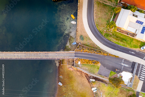 Aerial view over a fork in the road going over a bridge