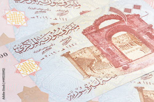 Syrian pound or Lira banknotes. Money of the Arabic country. Close up detailed money background wallpaper. Banknotes of the battered by the war country of Syria. Currency banknotes. 