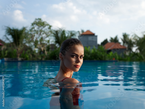 sexy woman with bare shoulders stands in a pool of clear water Exotic model © SHOTPRIME STUDIO