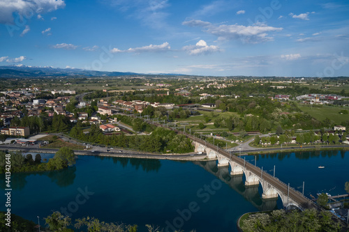 Panoramic aerial view of the railway bridge over the river. Peschiera del Garda, Italy. Aerial view of the resort town on Lake Garda.