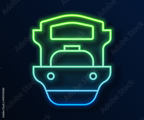 Glowing neon line Oil tanker ship icon isolated on blue background. Vector