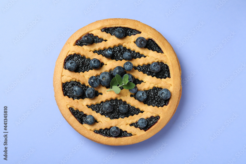 Delicious blueberry pie on violet background, top view Delicious blueberry pie on violet background, top view