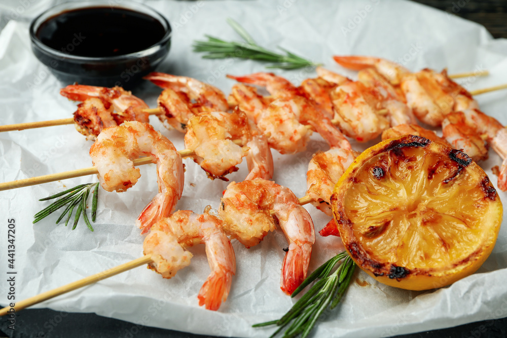 Tasty grilled shrimps on baking paper, close up Tasty grilled shrimps on baking paper, close up