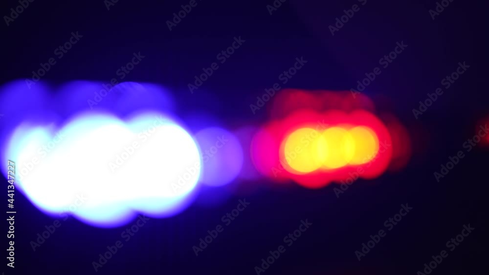 Lens flares from a police car flashers. Red and blue light flash
