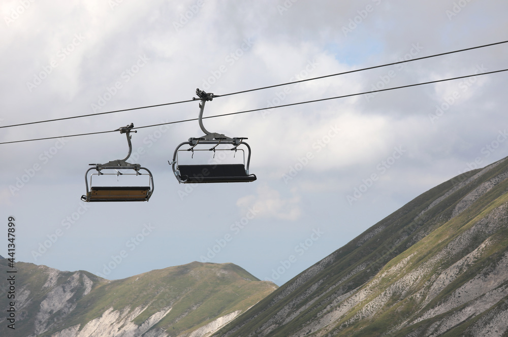 two chairlifts in the mountains to transport tourists of hikers effortlessly
