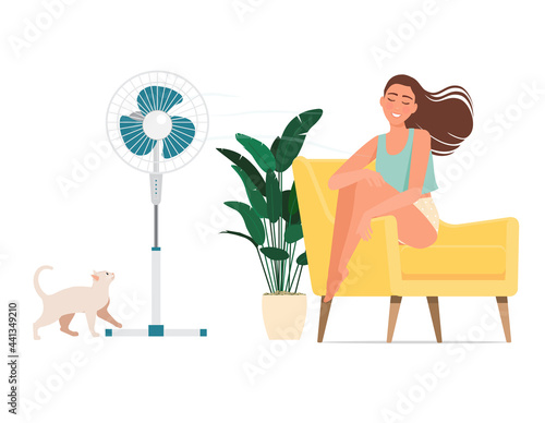 A girl gets blown by a fan on a hot day