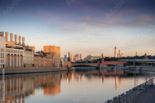 View of the Moscow towers and cathedrals and reflections on the Moscow River in an early sunny golden morning