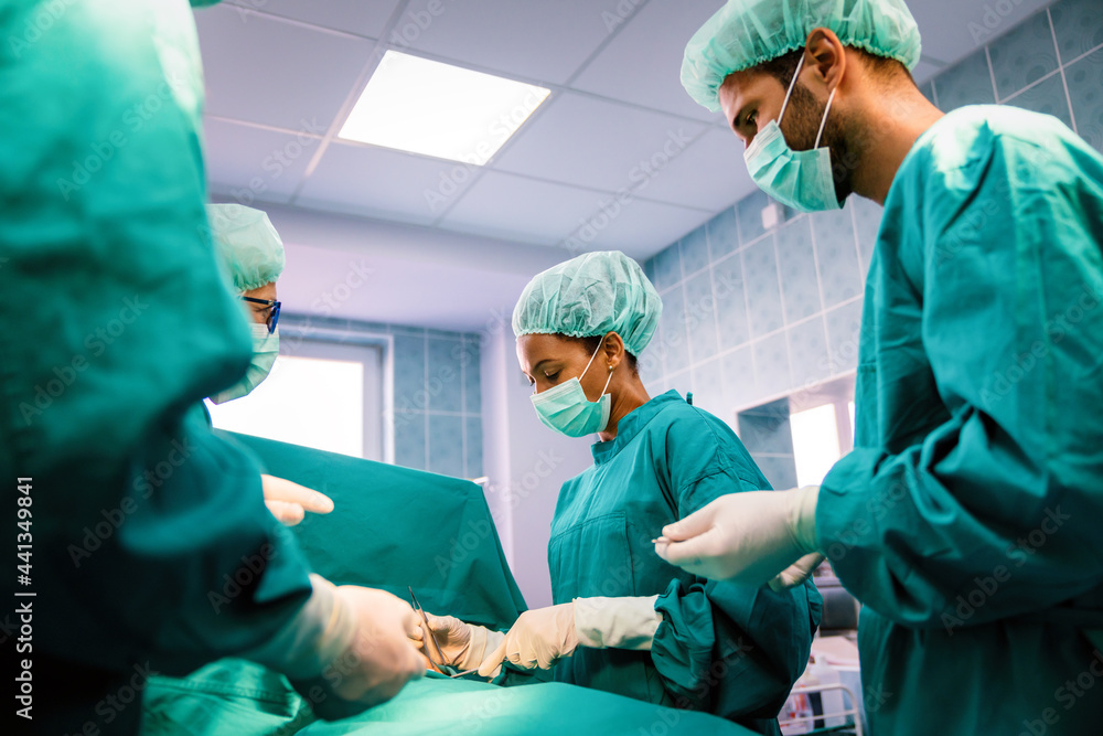 Group of surgeon team at work in operating room in hospital
