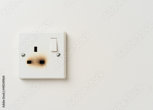 Fire damaged electrical wall power socket with copy space