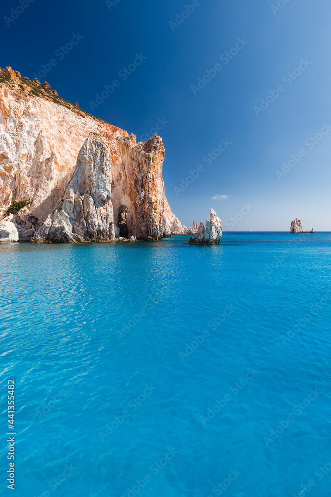 Fototapeta premium Spectacular rock faces on the turquoise sea of the south coast of the uninhabited island of Poliegos near Milos in the Greek Cyclades