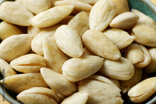 Blanched almonds in a bowl. Bowl with skinless nuts. photo