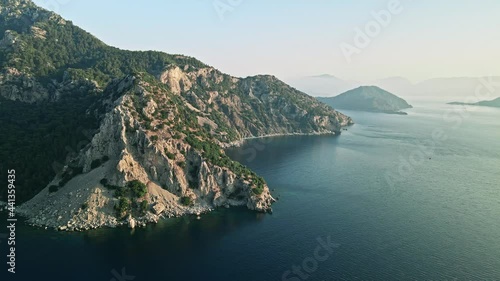 Rocky mountains of the Mediterranean sea at sunrise, islands in the background