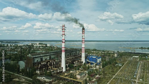 Aerial view of old coal power plant with black smoke from chimneys. Ecology and greenhouse effect.