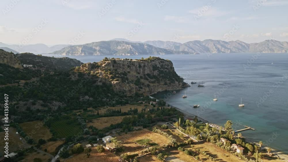 Aerial view of the Aegean sea with mountains and coastline with sailboats in the background of the island Aerial view of the Aegean sea with mountains and coastline with sailboats in the background of the island