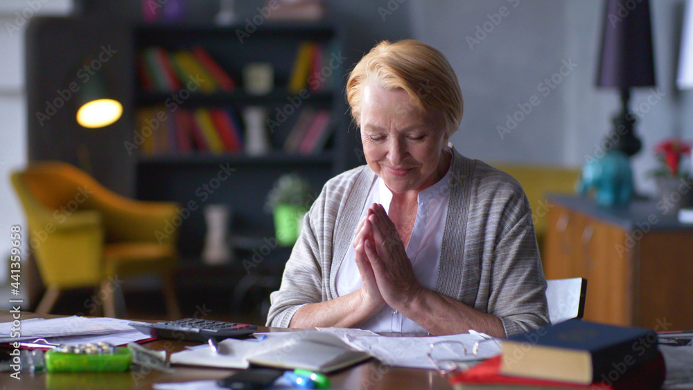 Pensive smiling mature lady feeling pleased counting income Pensive smiling mature lady feeling pleased counting income