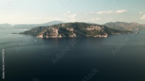 Rocky mountains of the Mediterranean sea at sunset, Marmaris in the background