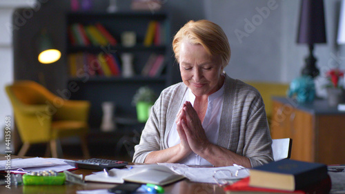 Obraz na plátne Pensive smiling mature lady feeling pleased counting income