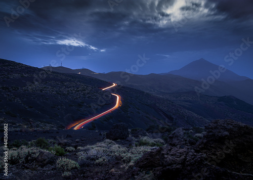Car lights illuminate a road at night in Teide National Park, near the Izaña astronomical observatory, in Tenerife, Canary Islands.