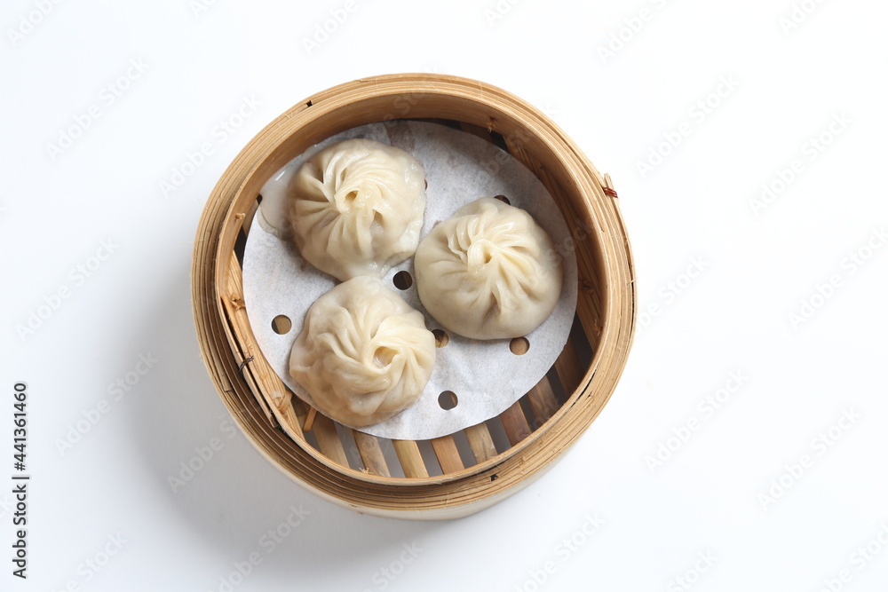 steamed Xiao long bao Shanghai small meat dumpling in bamboo basket with ginger vinegar dim sum