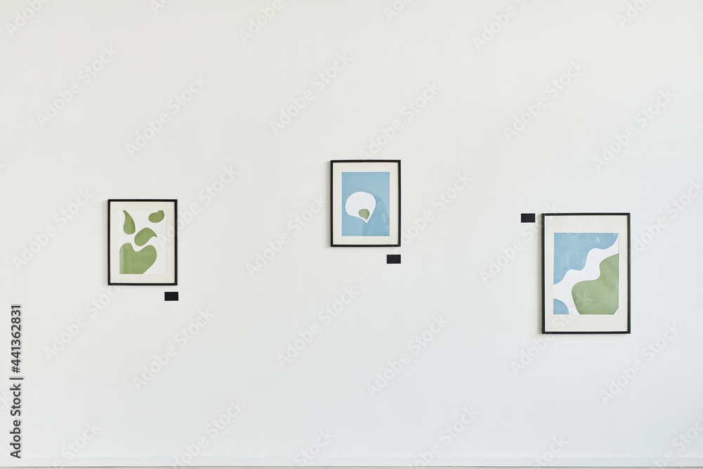 Minimal background image of three abstract paintings on white wall in contemporary art gallery, copy space Minimal background image of three abstract paintings on white wall in contemporary art gallery, copy space