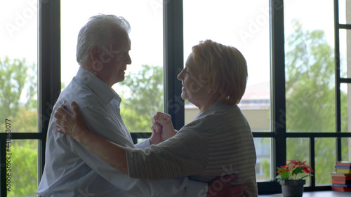 Lovely senior wife and husband dancing tango at home