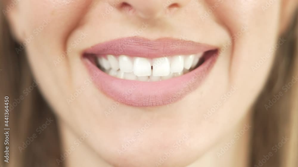 Close up of smiling teeth isolated. Detail of a smile woman. Young successful girl is smiling. Dentistry and teeth whitening concept Close up of smiling teeth isolated. Detail of a smile woman. Young successful girl is smiling. Dentistry and teeth whitening concept