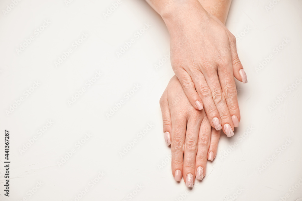 Woman hands with beautiful manicure on light background Woman hands with beautiful manicure on light background