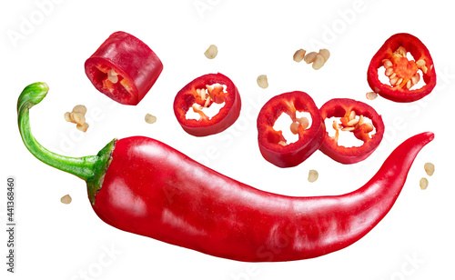 Leinwand Poster Fresh red chilli pepper and cross sections of chilli pepper with seeds floating in the air