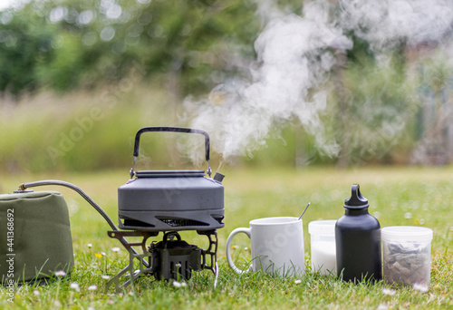 Canvas Print Kettle boiling on a camping stove to make a cup of tea whist camping