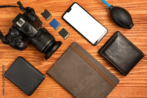 Journalistic equipment - notebook, phone, camera, lens, wallet and different objects. Moderninvestigative concept. Freelancers outfit. Clipping mask for screen