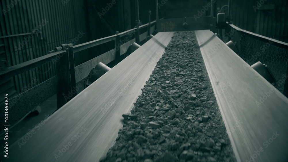 Fototapeta premium Industrial belt conveyor moving raw materials from mine