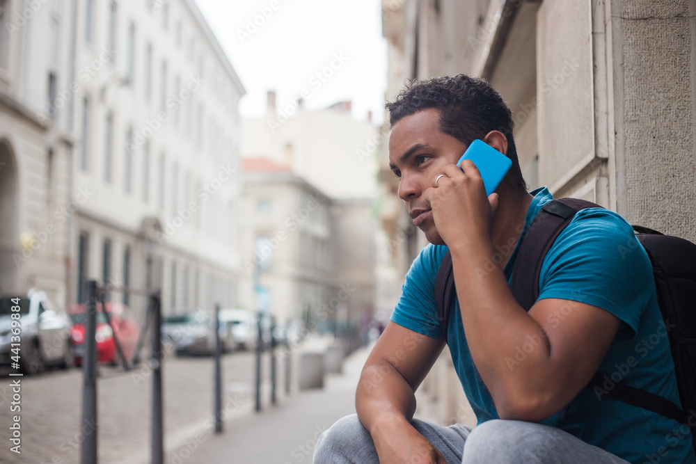 Fototapeta premium Latin tourist man in Europe with his smartphone