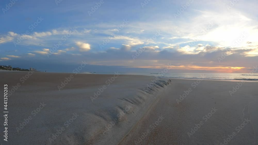 An angled ridge of sand leads the viewer to the golden sunrise ...