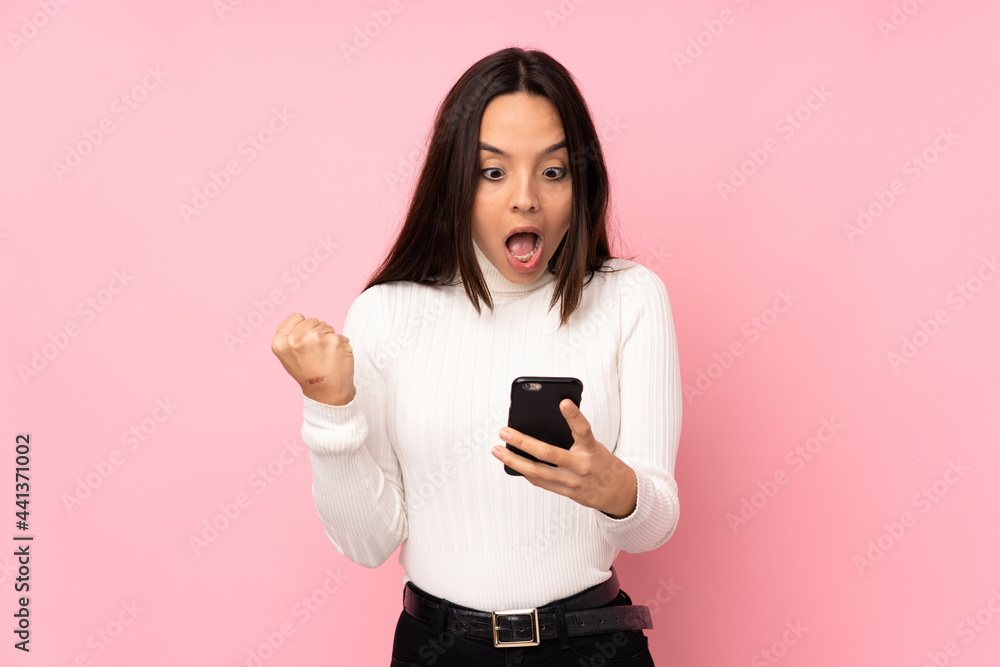 Young woman with a mobile over isolated background Young woman with a mobile over isolated background