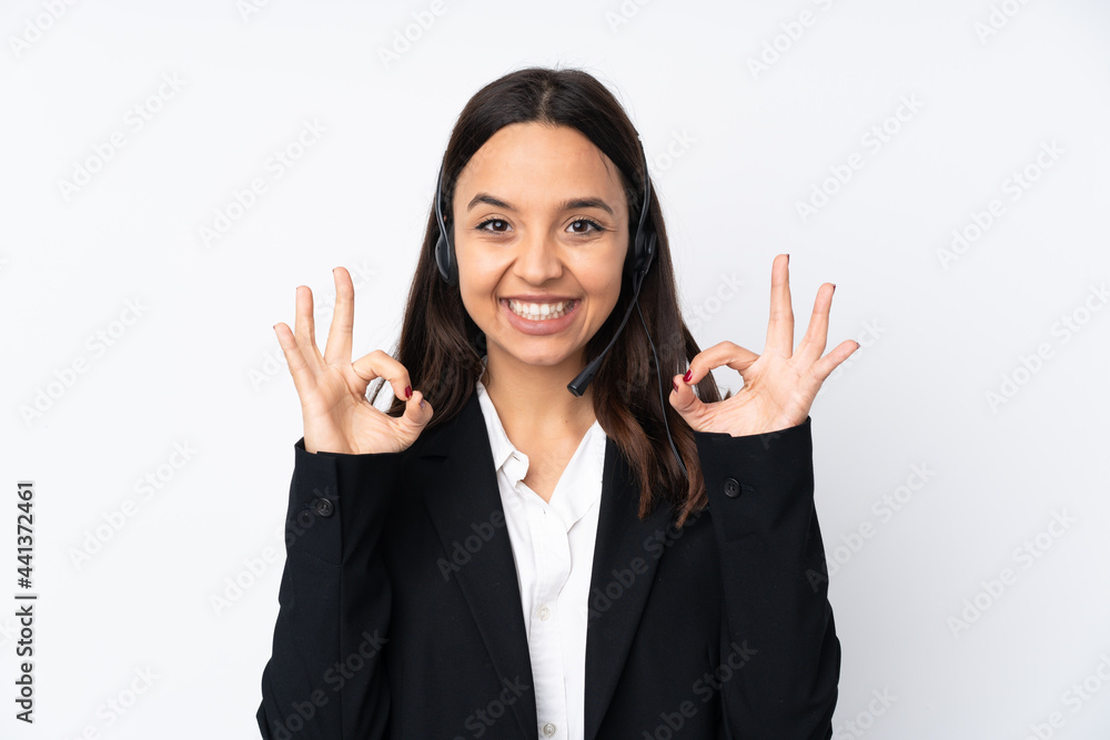Young telemarketer woman isolated on white background showing an ok sign with fingers Young telemarketer woman isolated on white background showing an ok sign with fingers