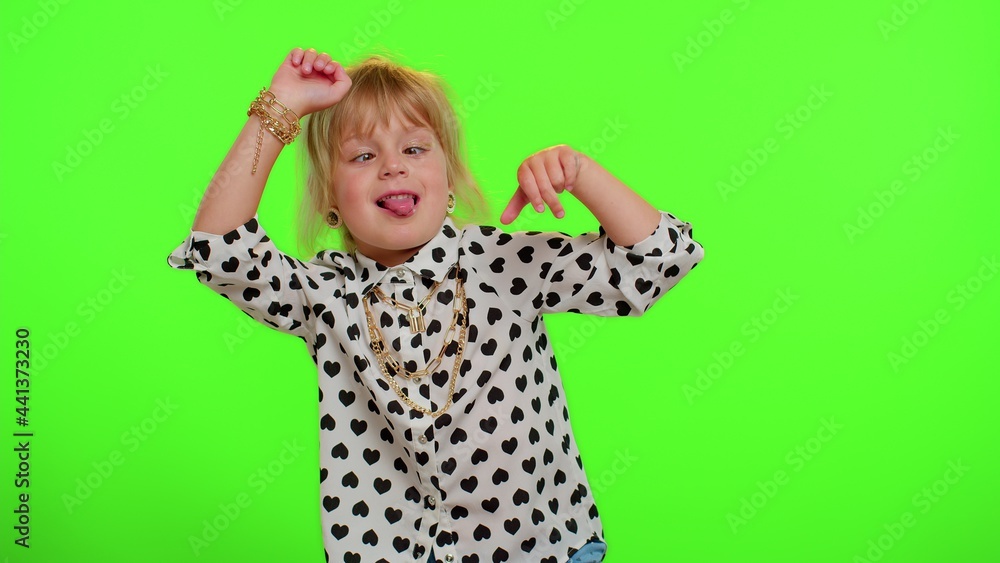 Funny teen child kid girl making playful silly facial expressions and grimacing, fooling around, showing tongue. Posing isolated on chroma key green background. Childhood lifestyle. Young children Funny teen child kid girl making playful silly facial expressions and grimacing, fooling around, showing tongue. Posing isolated on chroma key green background. Childhood lifestyle. Young children