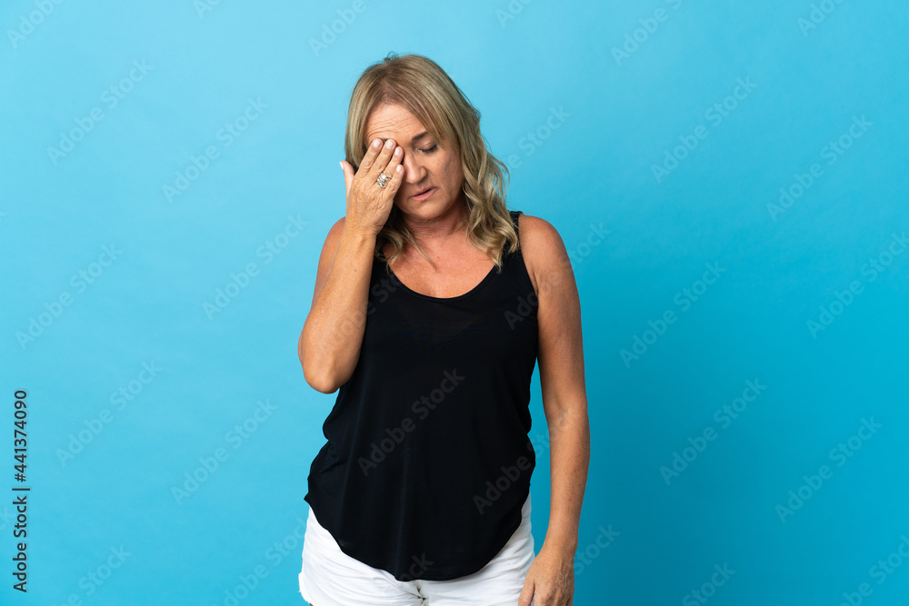 Middle aged blonde woman over isolated background with headache Middle aged blonde woman over isolated background with headache