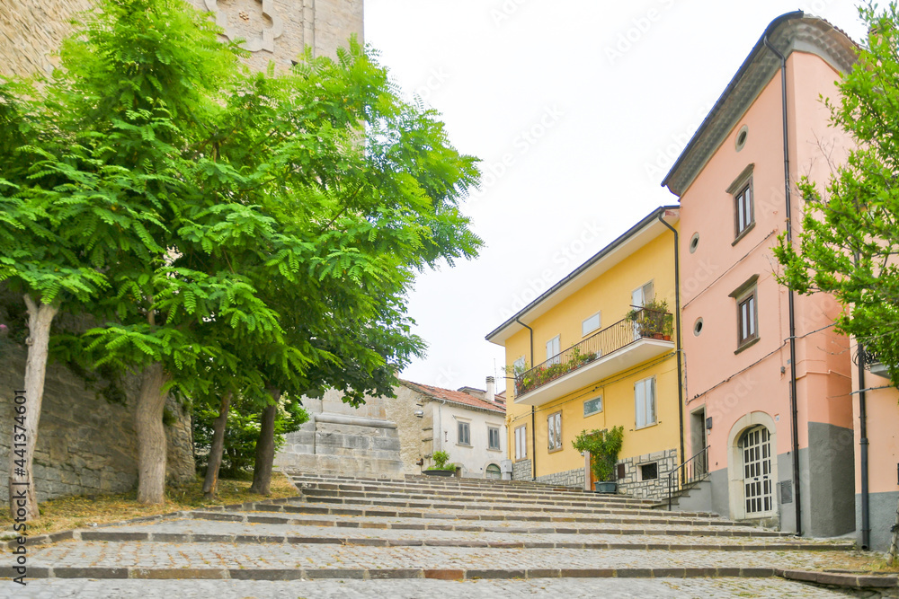 A small street between the old houses of Agnone, a medieval village in the mountains of the Molise region, Italy.