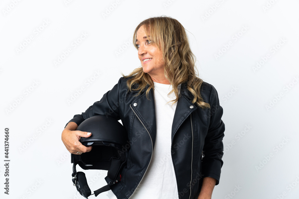 Middle aged biker over isolated white background looking side Middle aged biker over isolated white background looking side