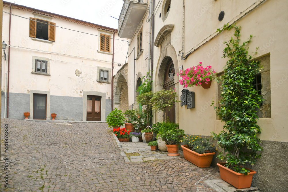 Naklejka premium A small street between the old houses of Agnone, a medieval village in the mountains of the Molise region, Italy.