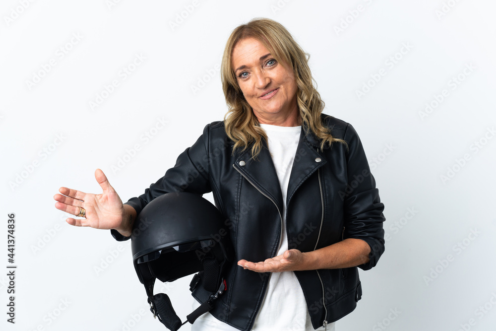 Middle aged biker over isolated white background extending hands to the side for inviting to come Middle aged biker over isolated white background extending hands to the side for inviting to come
