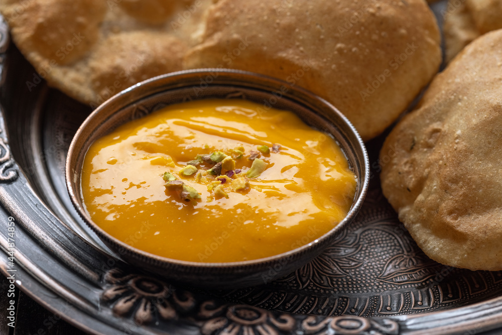 Aam Ras Puri or Alphonso Mango pulp with fried Poori Aam Ras Puri or Alphonso Mango pulp with fried Poori