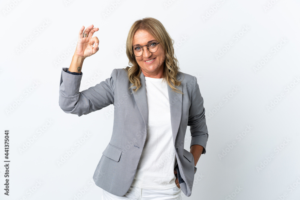 Middle aged business woman over isolated white background showing ok sign with fingers Middle aged business woman over isolated white background showing ok sign with fingers