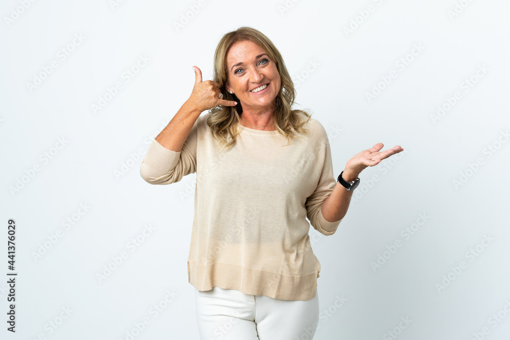 Middle aged blonde woman over isolated white background making phone gesture and doubting Middle aged blonde woman over isolated white background making phone gesture and doubting