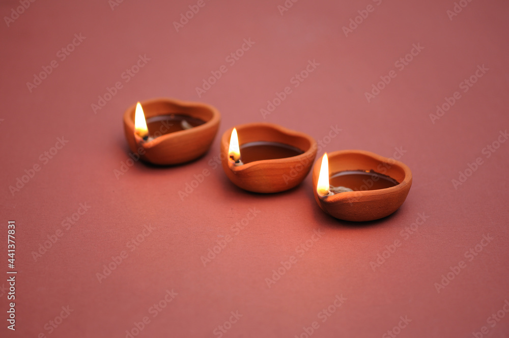 Happy Diwali - clay diya lamps lit during diwali celebration 