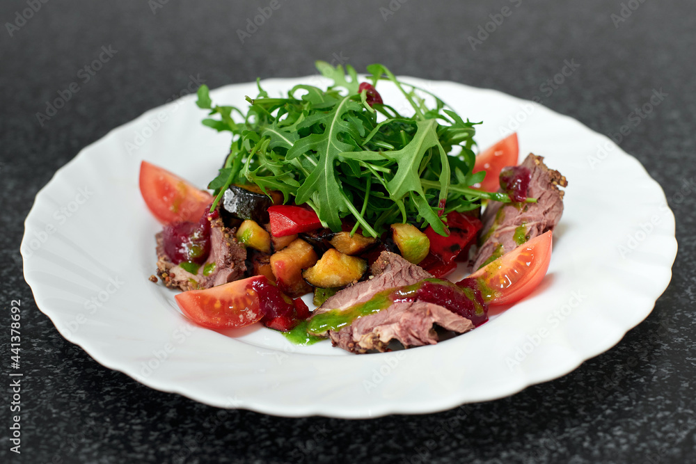 Delicious salad with beef, fresh and grilled vegetables, arugula Delicious salad with beef, fresh and grilled vegetables, arugula
